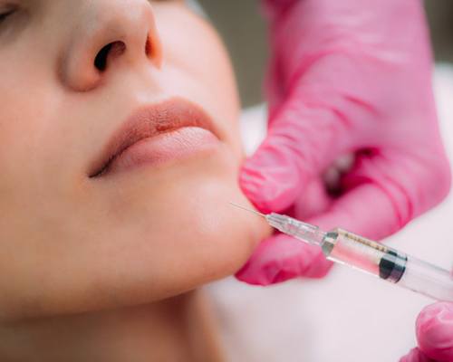 a patient receiving dermal fillers from her dentist