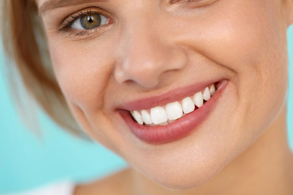 Closeup of woman with hazel eyes and blond hair smiling